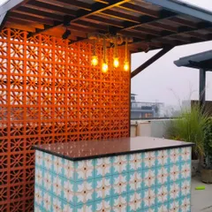 A closer look at the Palam Vihar bar, showing the beautiful tile work and the industrial-style pendant lights hanging above the counter.