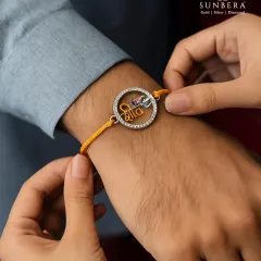 A silver rakhi is more than a thread, it is a keepsake. Here, our 'Veera' rakhi, featuring the word for brother in Hindi, is tied on a wrist, showcasing its elegant design and comfortable fit. It is a modern yet traditional way to celebrate Raksha Bandhan.