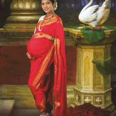 Inspired by the timeless art of Ravi Varma, this is a truly special traditional maternity portrait. We created a rich, painterly look to celebrate motherhood with classic Indian elegance in a red saree.