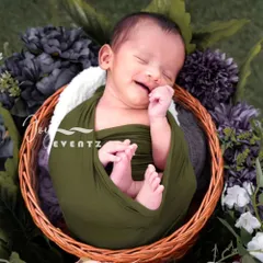 The pure bliss of a newborn's smile is a moment to cherish forever. We specialize in newborn photography in Bangalore, ensuring a safe and comfortable session where your baby is gently swaddled and posed in our cozy, floral-themed props.