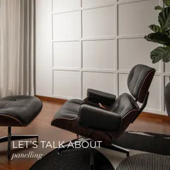Let's talk about paneling. Here, classic square wall paneling adds architectural detail and depth to a simple wall, creating a sophisticated backdrop for an iconic Eames lounge chair.