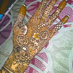 I love the complexity of a full-palm design. This one features a mix of floral patterns, geometric fills, and detailed finger work, all done with my organic henna.