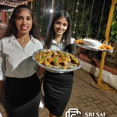 Our welcome hostesses do more than just greet guests; they create a warm and inviting atmosphere from the very beginning. Here, they are serving appetizers with a smile, demonstrating the proactive and friendly hospitality that ensures every guest feels personally attended to throughout your event.