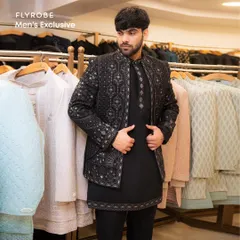 Make a bold statement at any sangeet or reception with this black-on-black Indo-western jacket set. The intricate embroidery adds a touch of luxury to a modern silhouette.