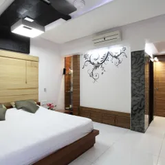 A bedroom in the renovated 'Zingy Home' project. We used a combination of clean lines, a custom wall decal, and a bamboo headboard to create a space that is both modern and warm, demonstrating our attention to personalized details.