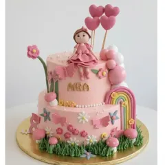 This sweet two-tier cake was designed for Aira's birthday. It's a rich chocolate truffle cake with a whimsical garden theme, complete with a handmade doll, a rainbow, and floral details all made from fondant.