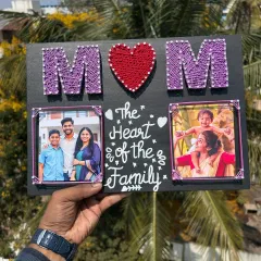 This string art frame makes a perfect gift for Mother's Day. It features the word "MOM" created with string, along with two of your favorite photos and a heartfelt message.