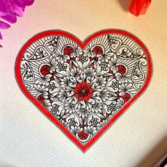 A piece of love, just for you. This heart-shaped mandala is filled with intricate floral patterns in red and black, making it a perfect piece to celebrate love and connection.