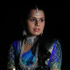 For a glamorous reception, I created this stunning look using dramatic lighting to highlight the bride's features. The makeup is paired with elegant diamond jewellery and a rich blue silk saree, perfect for an evening celebration.