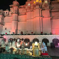 An opulent buffet setup for a destination wedding in Udaipur. The decor, featuring ornate lanterns and traditional serveware, was designed to complement the royal architecture of the palace and create a truly luxurious dining experience.
