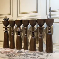 This is where furniture design meets modern, abstract art. The Seven Pillars Console is a poetic piece crafted from rich wood, with seven unique vertical elements that tell a story of curves and creativity. It is more than furniture; it is a conversation starter.
