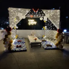A wider view of the terrace cabana decoration, showing the balloon columns and the open-air feel. This setup is perfect for enjoying an evening celebration with a view of the Bengaluru skyline.
