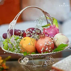 An elegantly designed silver-plated fruit basket, filled with fresh fruits and baby's breath. This piece adds a touch of sophistication to wedding celebrations and festive decor, making any table feel more welcoming.