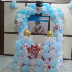 A winter-themed balloon stall created for a school event. The blue and white balloons, along with snowman and snowflake foil balloons, create a festive and fun photo or activity booth.