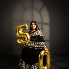 An elegant studio portrait for a 50th birthday. The dramatic lighting and classic pose create a timeless and sophisticated image, celebrating five decades of life.
