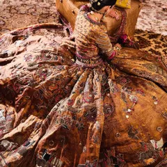 An artistic shot showcasing the incredible detail of a vintage-inspired lehenga from Delhi Vintage Co. The rich, earthy tones and intricate embroidery are a work of art.