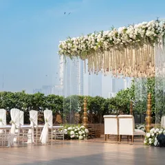 The mandap set against the Mumbai skyline, showing how we integrate urban backdrops with elegant decor. The transparent pillars ensure the city view remains a part of the scenic design.