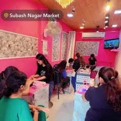 Another angle of my Subhash Nagar Market studio, bustling with students engaged in practical nail sessions. The space is set up to facilitate group learning and individual practice.