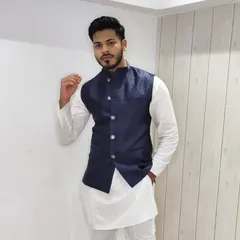 The navy blue Bandi jacket is a timeless choice that pairs perfectly with a crisp white kurta. This combination is effortlessly stylish and suitable for a Sangeet or engagement party.