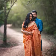 The elegance of a saree adds another level of beauty to a portrait. This image of a couple, rendered in both color and black and white, is a perfect example of timeless romance.