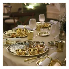 A close-up of our traditional thali service, featuring exquisite hammered gold and silver tableware. This service celebrates India's rich culinary legacy with a touch of royal splendour.