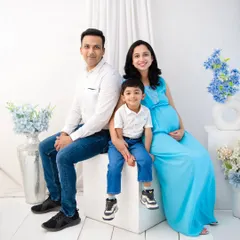 The complete family, seated together in our bright, minimalist studio. This classic family portrait is clean, timeless, and full of love, perfectly capturing this special moment in time.