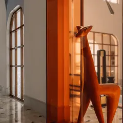This wooden sculpture, housed in a deep amber glass case, is the 'pièce de résistance' of the main galleria. We placed it strategically to break the circulation spine and spark conversation, proving that art can add immense value and narrative to a space.