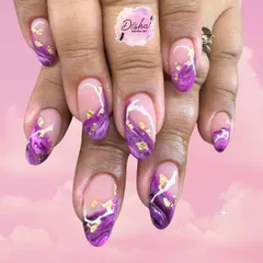 Some nails just look purely magical. This design features a purple marble effect on a sheer base, accented with delicate gold flakes.