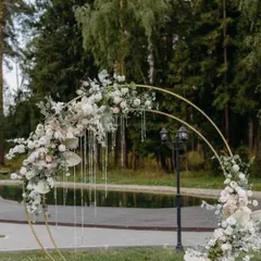 A stunning circular photo booth arch adorned with white and blush flowers and hanging crystals. It's a perfect Pinterest-worthy spot for photos.