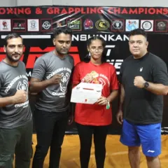 A student receiving her certificate at our in-house Kickboxing & Grappling Championship. We believe in giving our students a platform to test their skills and gain valuable competition experience.