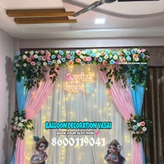 A closer look at a traditional Dohale Jevan setup, highlighting the floral valance and the soft glow of fairy lights behind the drapes. This kind of decoration creates a perfect, cozy spot for the mother-to-be.