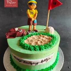 A golf-themed cake for a 35th birthday, featuring a green, a sand trap, and a personalized golfer figurine.