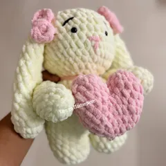 Nothing says 'cuddly' like a plushie toy made with super soft, chunky yarn. This adorable bunny holding a heart is designed to be the perfect snuggle companion, handmade with gentle materials safe for all ages.
