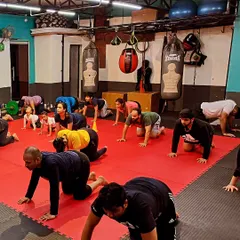 The squad is focused during a floor-based mobility drill. Everyone, regardless of their level, puts in the work.