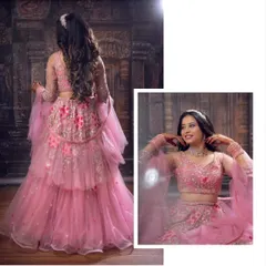 Pretty in pink. This tiered ruffle lehenga is a modern and playful choice for a bridesmaid or for a fun pre-wedding event. The matching jewellery is also available for rent.