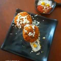 Crispy cheese corn balls served with a side of dip. These were part of a large evening snacks order that also included 50 cutlets and stuffed garlic bread.