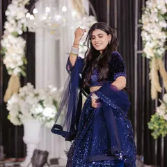 A beautiful shot of a bride mid-twirl, her blue lehenga and joyful expression capturing the magic of her solo dance.