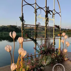The reception backdrop set against the still waters of a natural lake at sunset. The changing colors of the sky created the most beautiful, evolving canvas for the "Always & Forever" sign.