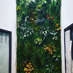 A close-up view of a mixed-foliage vertical garden. I combine different leaf shapes, colors, and sizes, including red and yellow accents, to create a vibrant and realistic plant wall.