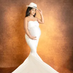 Adding a simple prop like a hat can bring a touch of personality and style to a classic fine-art drape portrait.