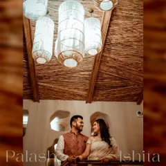 A beautifully composed shot of a couple during their Roka ceremony. The low angle highlights the warm, rustic decor of the venue and the couple's happy interaction.