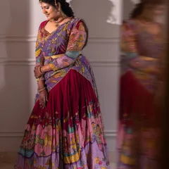 A full-length portrait of a woman in a magnificent, colorful lehenga, her reflection blurred beside her, symbolizing the dreamlike quality of her new home.