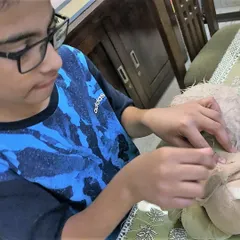 It is not just about fixing, it is about caring for the things we love. This young participant is carefully learning hand sewing techniques to mend his favorite stuffed toy, a skill that teaches patience and the value of preservation.