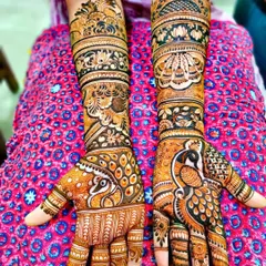 A vibrant design featuring large, detailed peacocks on the palms. The arms are decorated with a mix of floral and traditional patterns, creating a rich and full look.