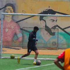 A player dribbling in front of the inspiring murals of sports legends that line our ground. The entire environment is designed to motivate and celebrate the spirit of the game.