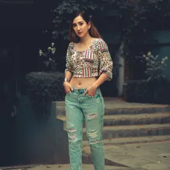 A full-body street style shot that showcases attitude and fashion. The cool-toned color grading and urban setting create a modern, grunge-inspired look.
