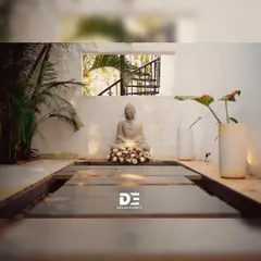 Creating a tranquil corner for a Haldi ceremony. A serene Buddha statue is adorned with a garland of white and red roses, blending spiritual calmness with celebratory aesthetics.
