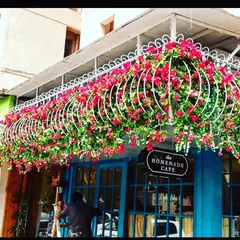 An eye-catching installation for "The Homemade Cafe". I used white metal frames filled with bright pink artificial bougainvillea to create a memorable and welcoming entrance.