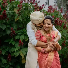 A warm embrace against a backdrop of lush greenery. We love using natural environments to create candid-style portraits that feel both intimate and full of life.