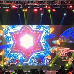 On a massive stage in Goa, performing with an incredible ensemble of musicians. These large-scale concerts are where the fusion of multiple Indian instruments creates a truly magical experience.